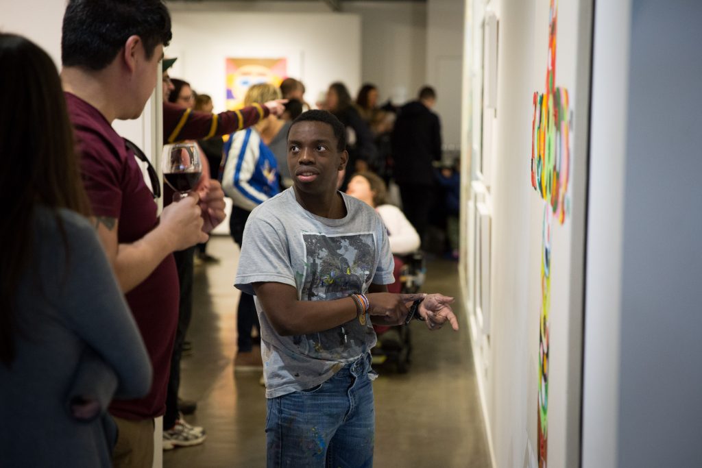 Artist Simeon Dicks at the 2018 group exhibition opening 'The Art of Living', curated by Rhys Lee at Arts Project Australia.